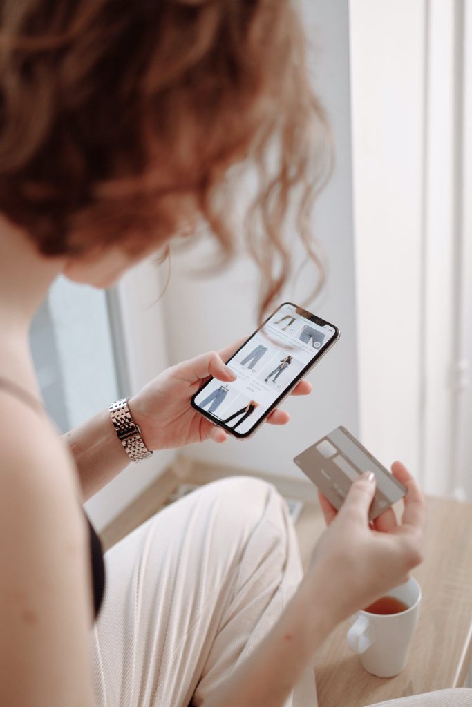 Veddys, Woman Holding Cellphone and a Credit Card